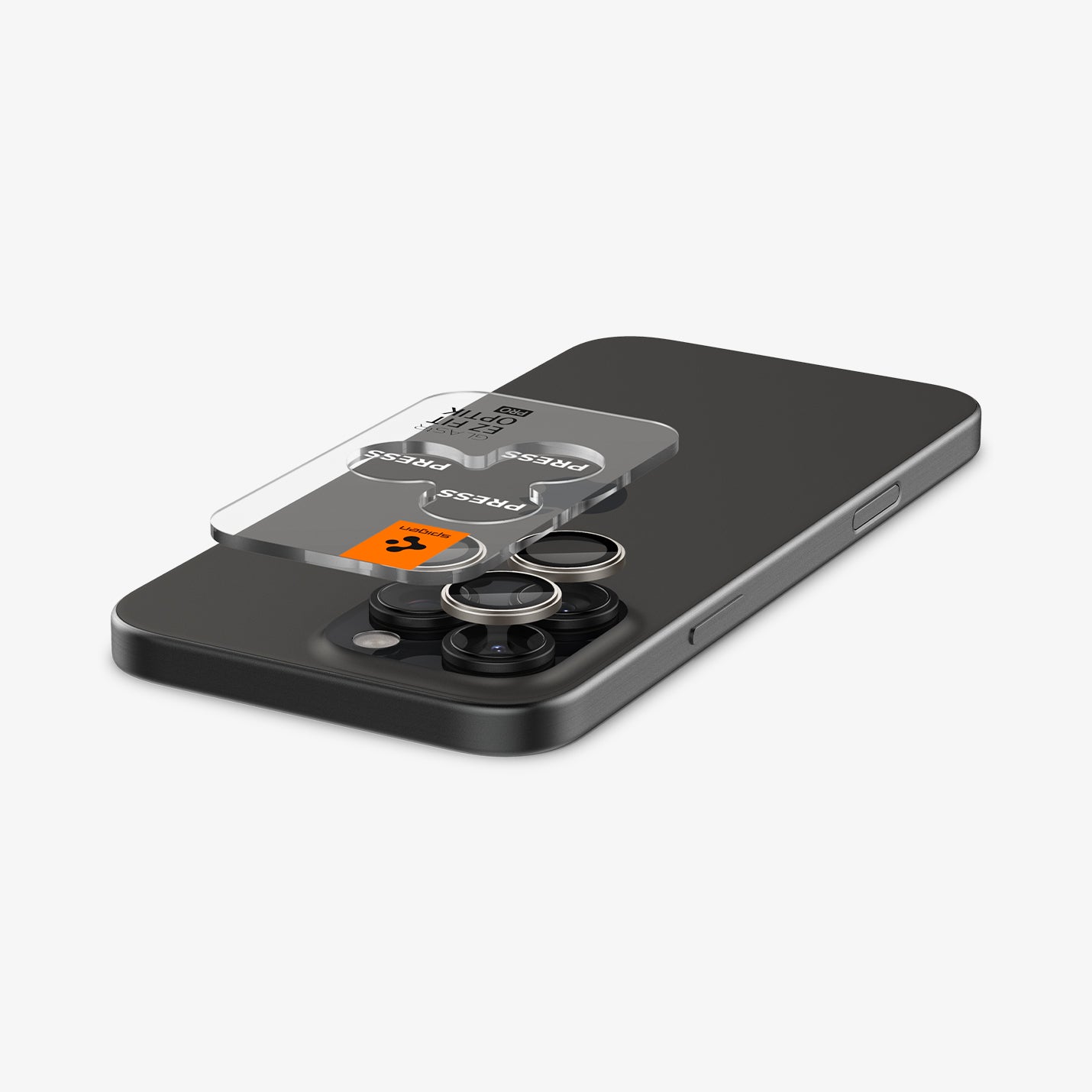 AGL08864 - iPhone 16 Pro Max / iPhone 16 Pro Optik Pro EZ Fit Lens Protector in Titanium showing the ez fit tray and lens protector hovering above the camera lens