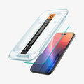 AGL07928 - iPhone 17 Pro / iPhone 17 GLAS.tR EZ Fit | Sensor Protected showing the installation tray hovering above the screen protector and the device