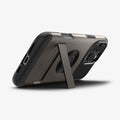 ACS08163 - iPhone 16 Pro Case Slim Armor (MagFit) in Gunmetal showing the back, partial side and bottom, propped up with a built-in kickstand