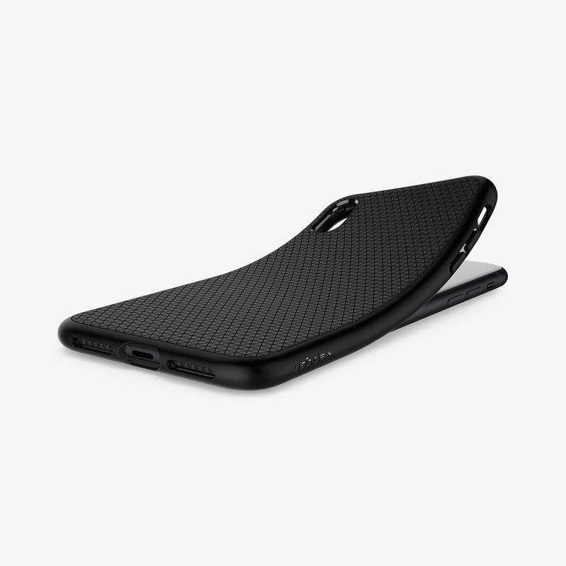 064CS24872 - iPhone XR Case Liquid Air in Black showing the back, partially peeled from behind a device on a flat surface