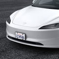 ACP08684 - License Plate Frame | LP100 in Black showing the front and partial sides, installed to the front of the car