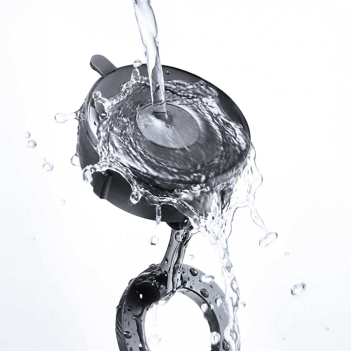 ACP11658 - Spigen Magnetic Car Mount (Mag Fit) MFT 36-1 showing water splashing over the suction base and magnetic ring to highlight durability