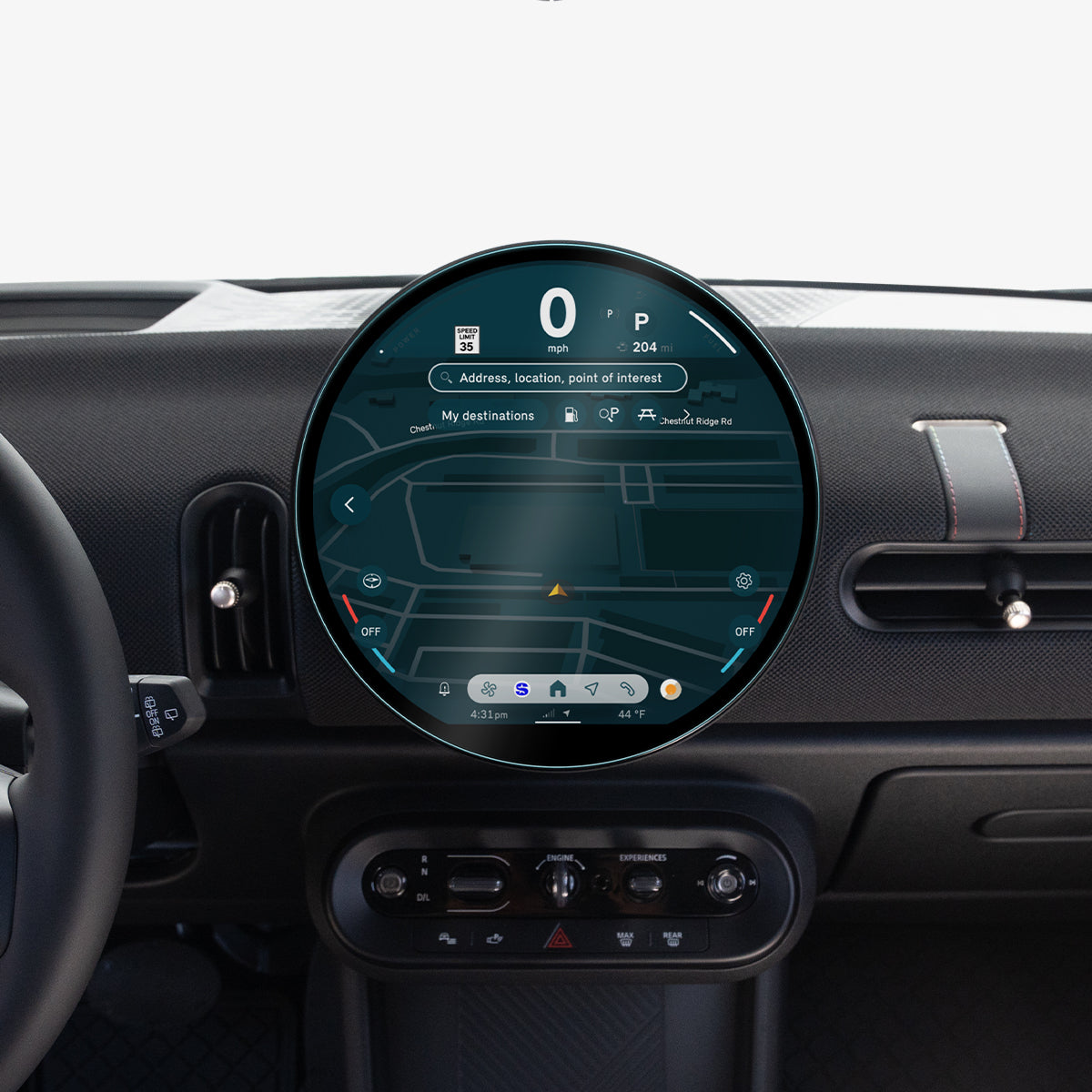 AGL09280 - Spigen display protector installed on a MINI Cooper's round dashboard screen, viewed from the driver's seat with the steering wheel in frame