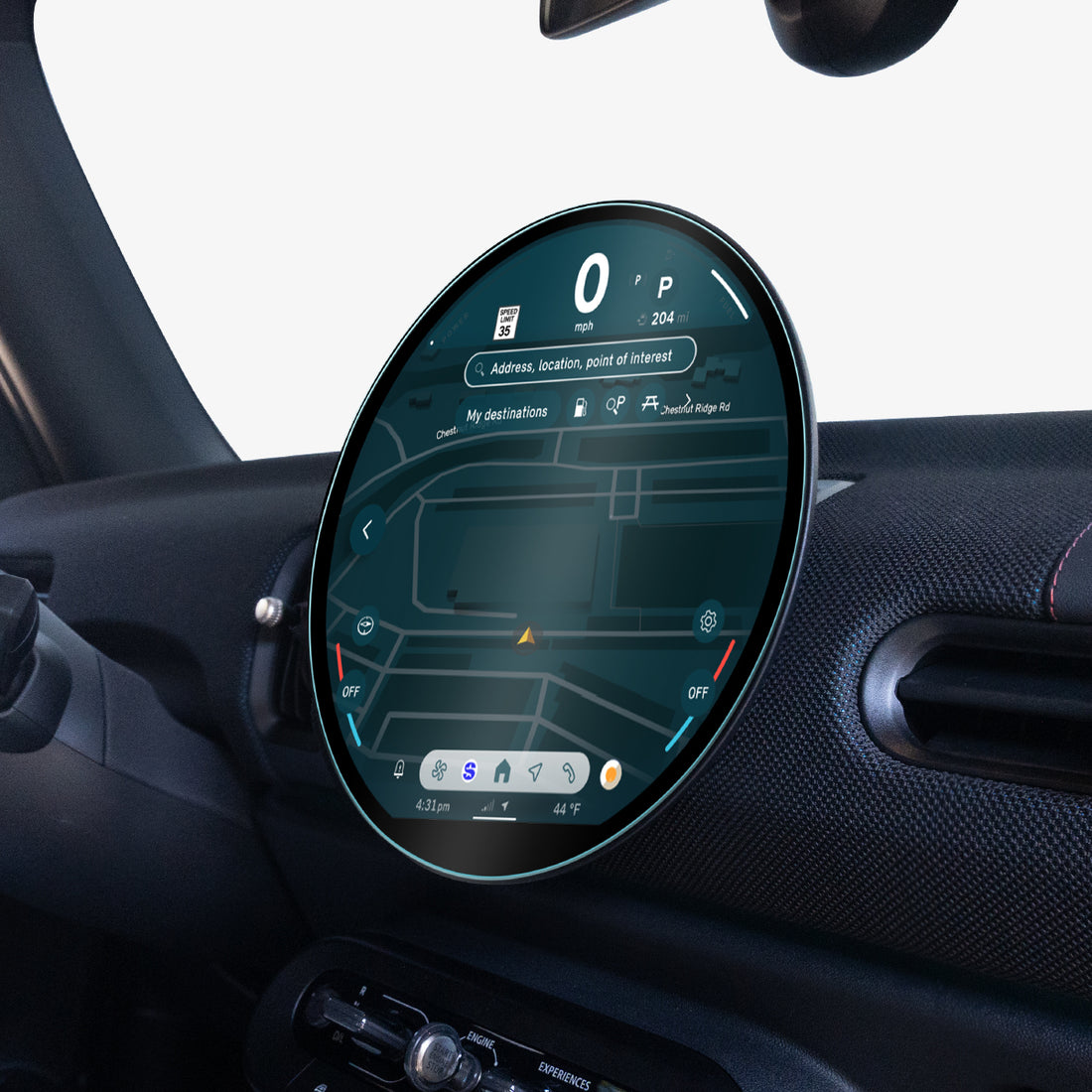 AGL09280 - Spigen display protector on a MINI Cooper's round dashboard screen, viewed at an angle from the passenger side near the window