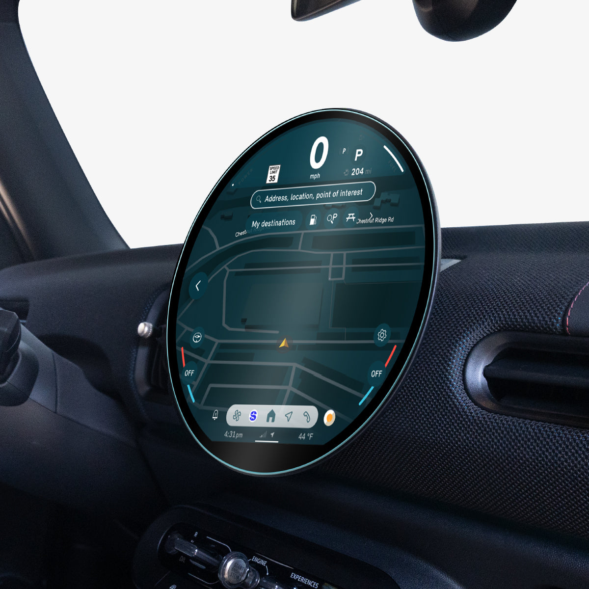 AGL09280 - Spigen display protector on a MINI Cooper's round dashboard screen, viewed at an angle from the passenger side near the window