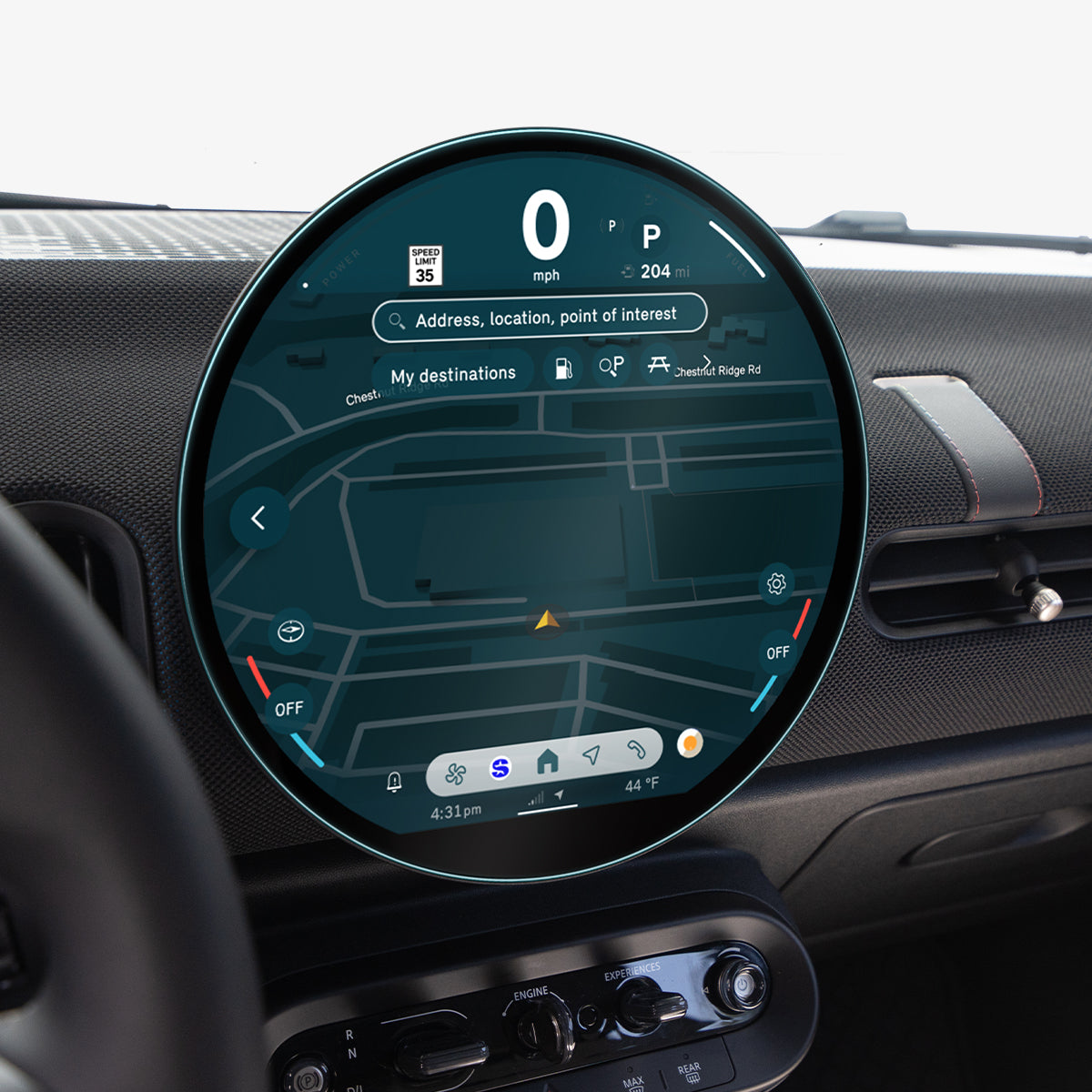 AGL09280 - Spigen display protector on a MINI Cooper's round dashboard screen, viewed at an angle near the steering wheel and rearview mirror