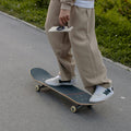 AMP09032 - MagSafe Phone Holder Nano Pop (MagFit) in Truffle Gray showing a person holding the device hands-free while riding on a skate board