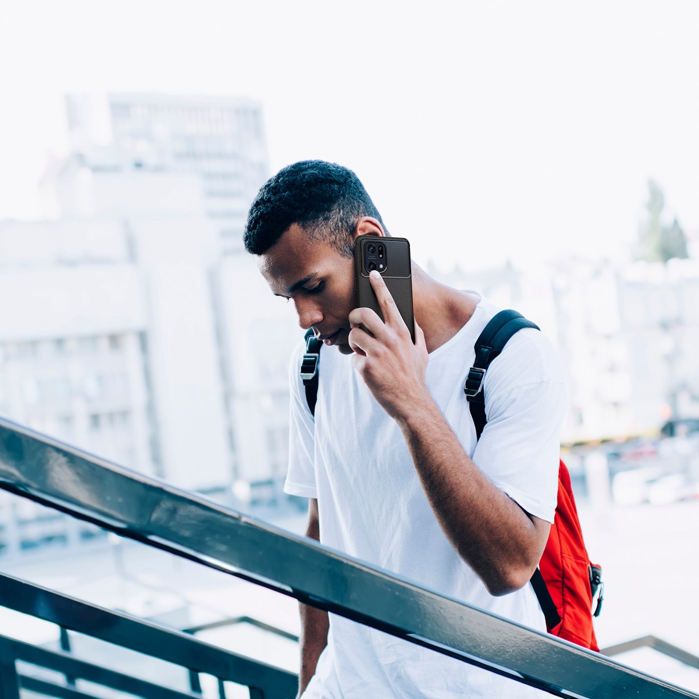 ACS04451 - OPPO Find Series Case Rugged Armor in black showing a man walking up the stairs while talking on the phone
