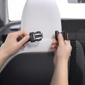 ACP11156 - Pet Car Backseat Barrier | PS200 in Black showing hands clipping the adjustable strap buckle around a car seat headrest to secure the mesh barrier in place.