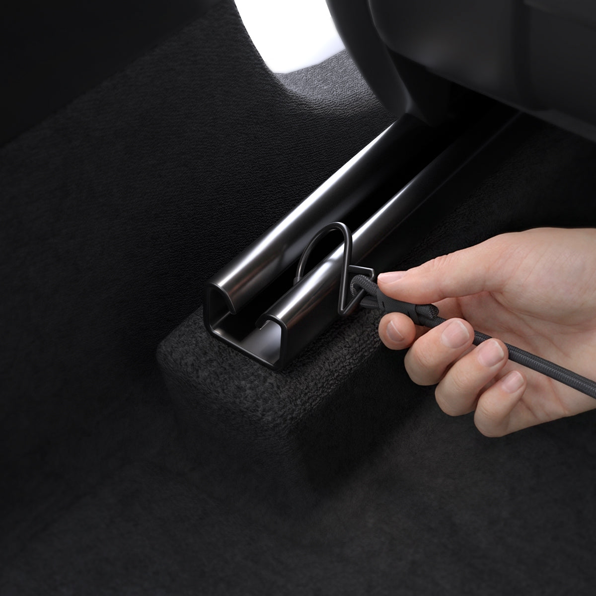 ACP11156 - Pet Car Backseat Barrier | PS200 in Black showing a hand attaching the lower hook strap to the seat rail to secure the barrier.