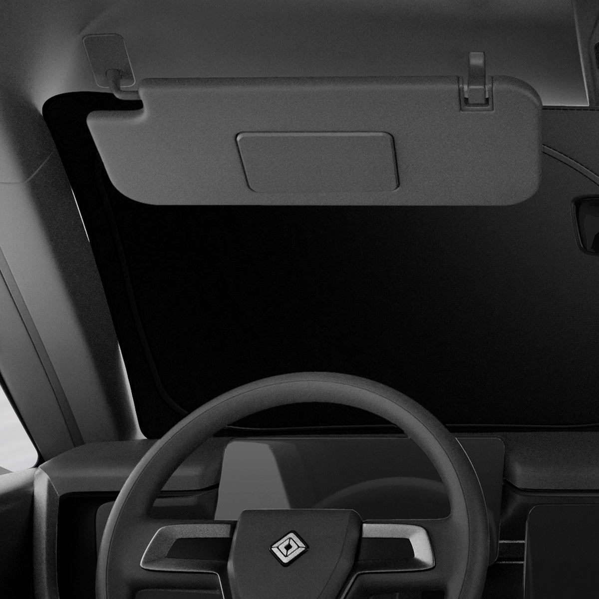 ACP09093 - R1S (2022-2025) Rivian CryoShade RO260 in Black showing the front of the driver's seat inside the vehicle with sunshade installed