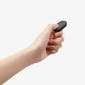 AMP11372 - Selfie Stick | S582W in Black showing a handheld Bluetooth remote control with a one-button shutter and LED indicator for wireless shooting.