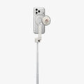 AMP11373 - Selfie Stick | S582W in Dune Beige showing a mounted smartphone with a magnetic holder and attached wireless remote on an extended telescopic pole for convenient shooting control.