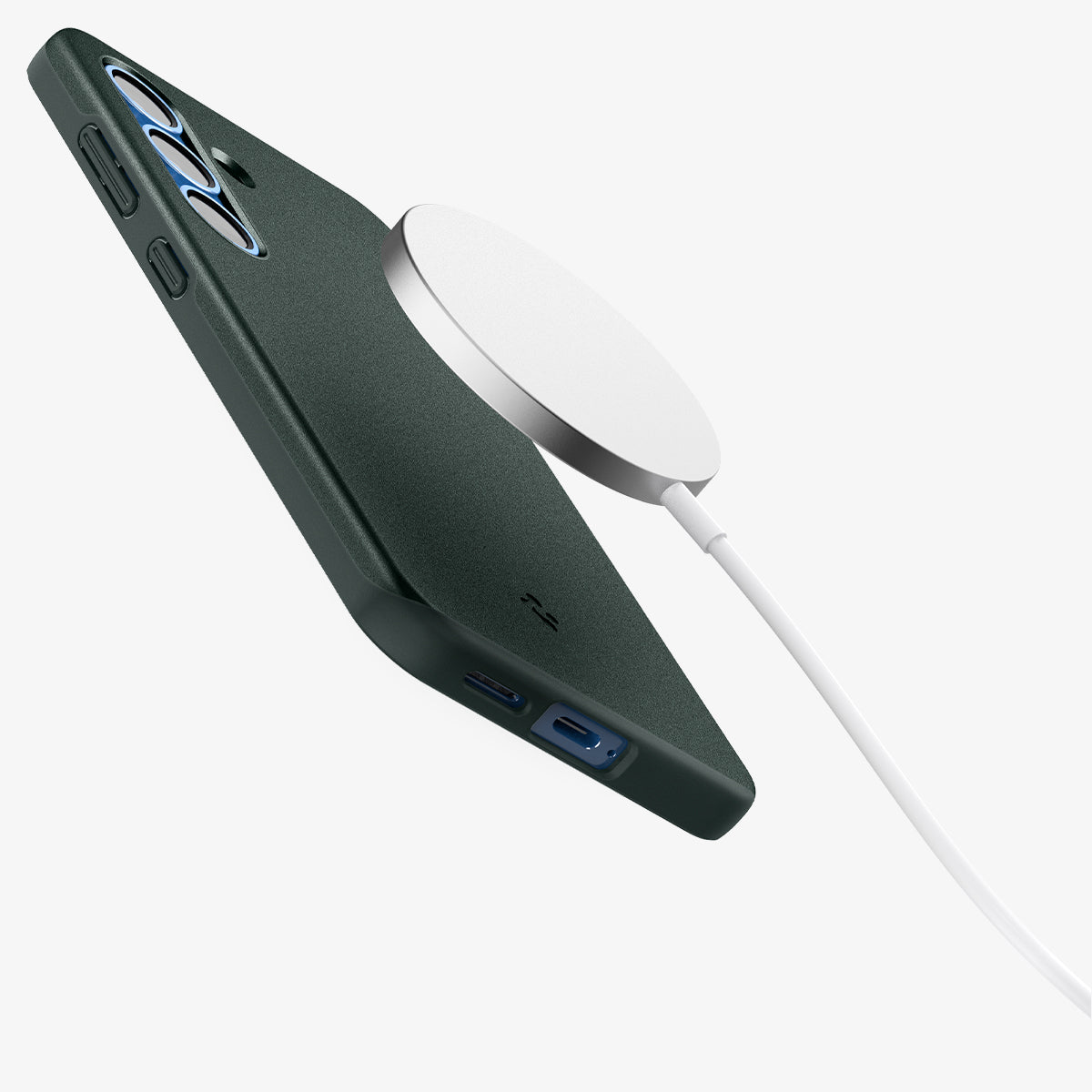 ACS08994 - Galaxy S25 Case Thin Fit (MagFit) in Abyss Green showing the back, partial side and bottom hovering in front of the magsafe charger