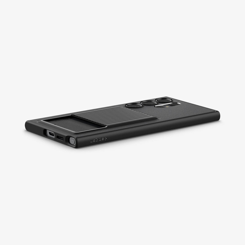 ACS07310 - Galaxy S24 Ultra Case Liquid Slot in Matte Black showing the back, partial bottom and side with a card slot on a flat surface