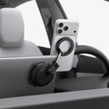 ACP11657 - Spigen MagSafe car mount holding iPhone on Tesla screen edge with suction cup base