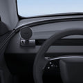 ACP11873 - Spigen magnetic phone mount folded down on a car dashboard near the steering wheel, showing the Spigen logo on the magnetic plate