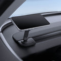ACP11873 - Spigen magnetic phone mount folded flat, holding a phone at a low angle on a car dashboard corner near the window