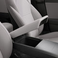 ACP12200 - Tesla Model Armrest Cover TO240H in Zen Gray showing the armrest cover lifted above the open center console storage compartment.