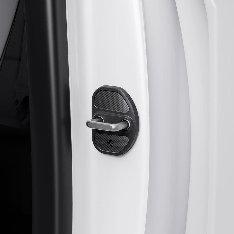 ACP07123 - Tesla Model Y & 3 Door Lock Cover TO320 in Black showing the hand of a man attaching the the lock cover to the door striker hook