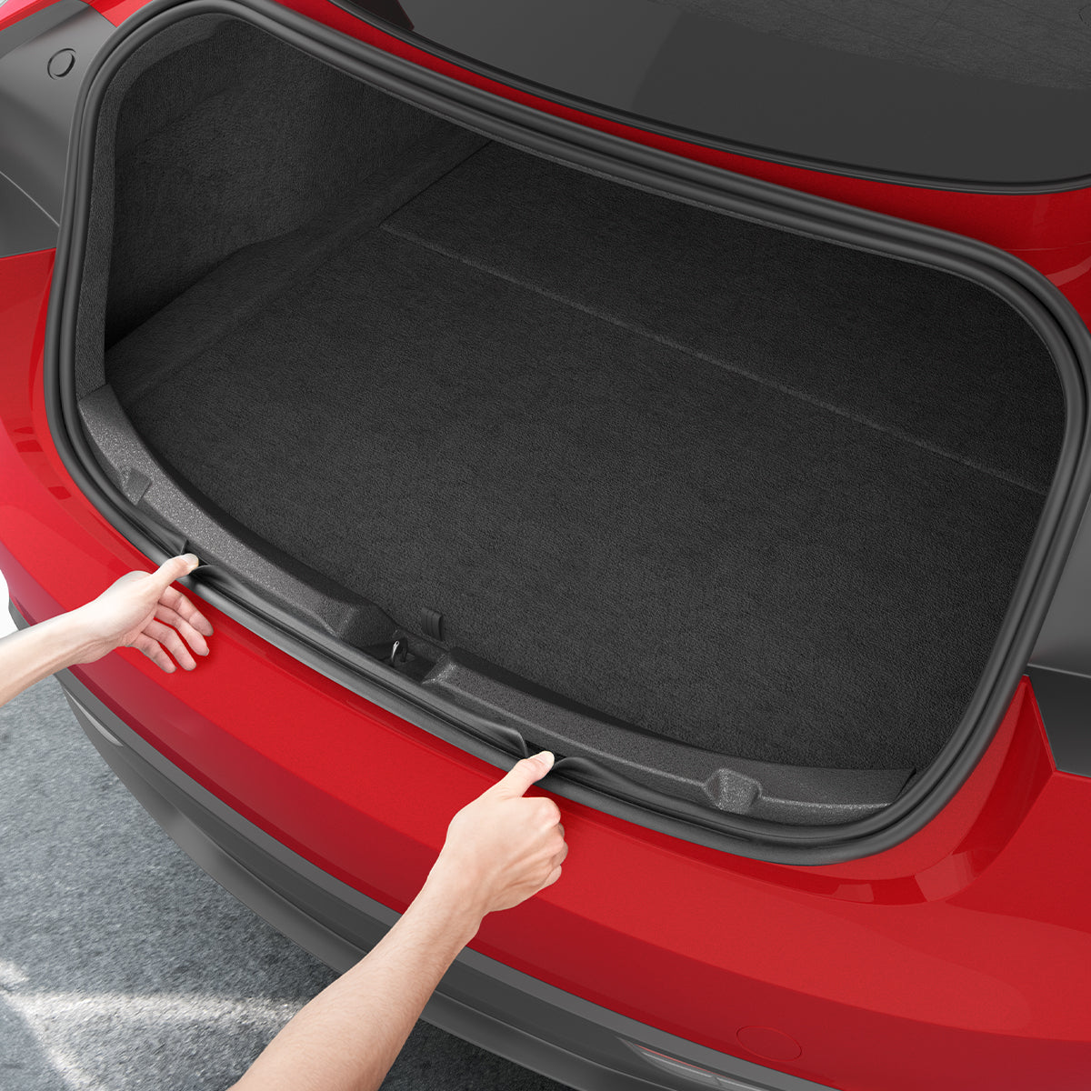 ACP11540 - Two hands pressing the Spigen bumper protector trim into both edges of an open Tesla trunk