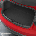 ACP11540 - Straight-on view of the black Spigen bumper scuff plate installed along a red Tesla's trunk edge