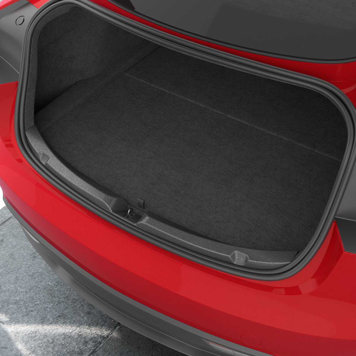 ACP11540 - Straight-on view of the black Spigen bumper scuff plate installed along a red Tesla's trunk edge
