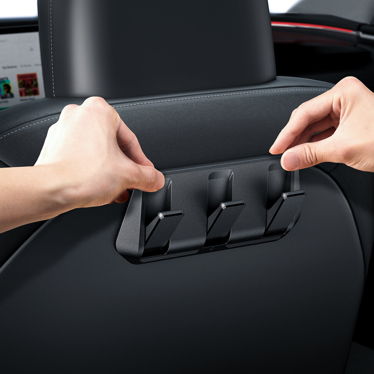 ACP09201 - Tesla Model 3 (2017-2023) Car Seat Hook TO283 in Black showing a person's hand attempting to install the car seat hook