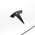 ACP08548 - Tesla Model 3 Highland Front Emblem Logo Cover TO321H in Carbon showing the front and sides