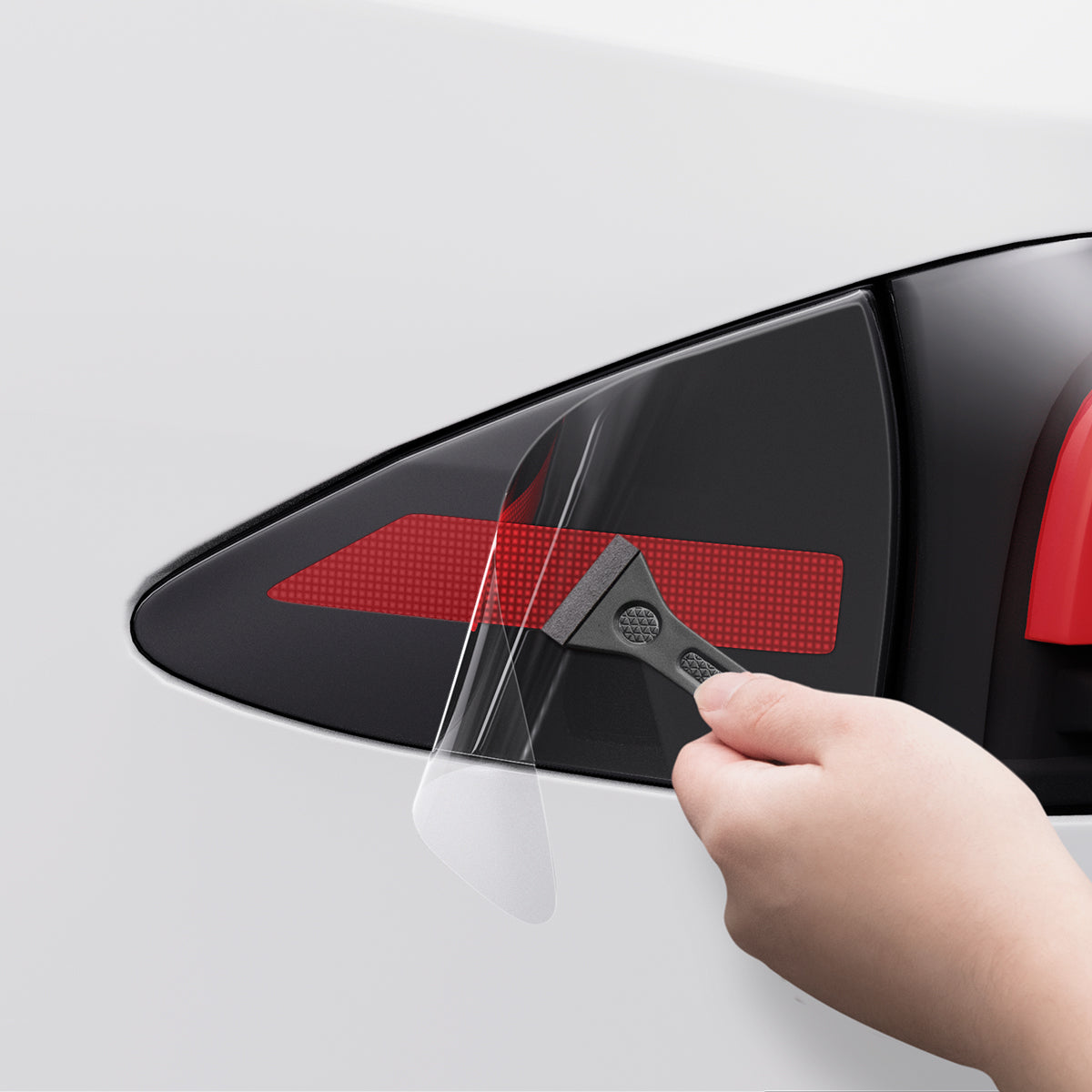 AFL07572 - Tesla Model S Charging Port Protective Film TO421 in Transparency showing the careful application of the protective film using the squeegee tool