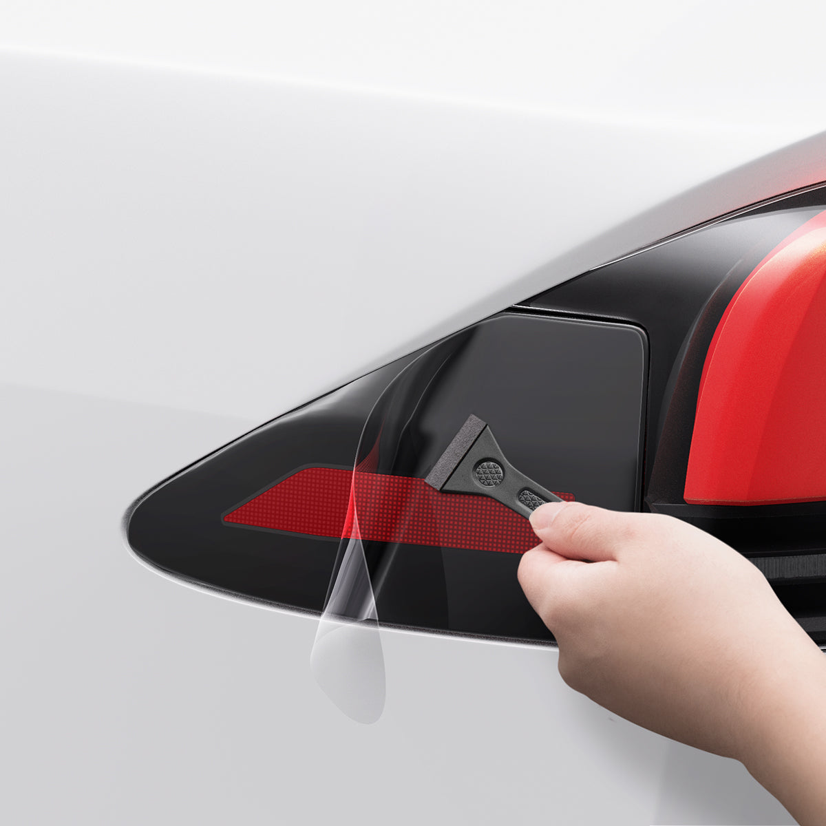 AFL07573 - Tesla Model X Charging Port Protective Film TO422 in Transparency showing the careful application of the protective film using the squeegee tool