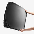 ACP11460 - Universal CryoShade UO260 M showing hands holding fully expanded black sunshade with reflective silver interior facing outward