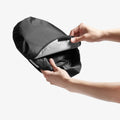 ACP11460 - Universal CryoShade UO260 M showing hands opening velcro closure on black storage pouch to insert folded sunshade
