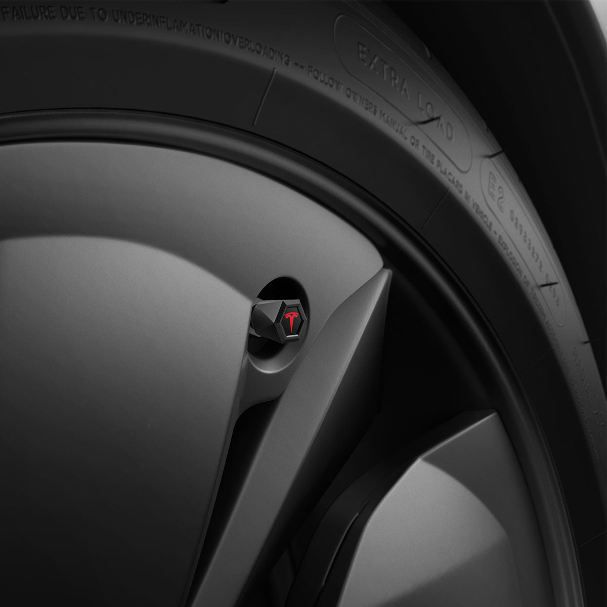 ACP11371 - Universal Tire Valve Stem Cap | VS100TS/R in Red showing the matte black hexagonal cap with red Tesla logo installed on a vehicle wheel.
