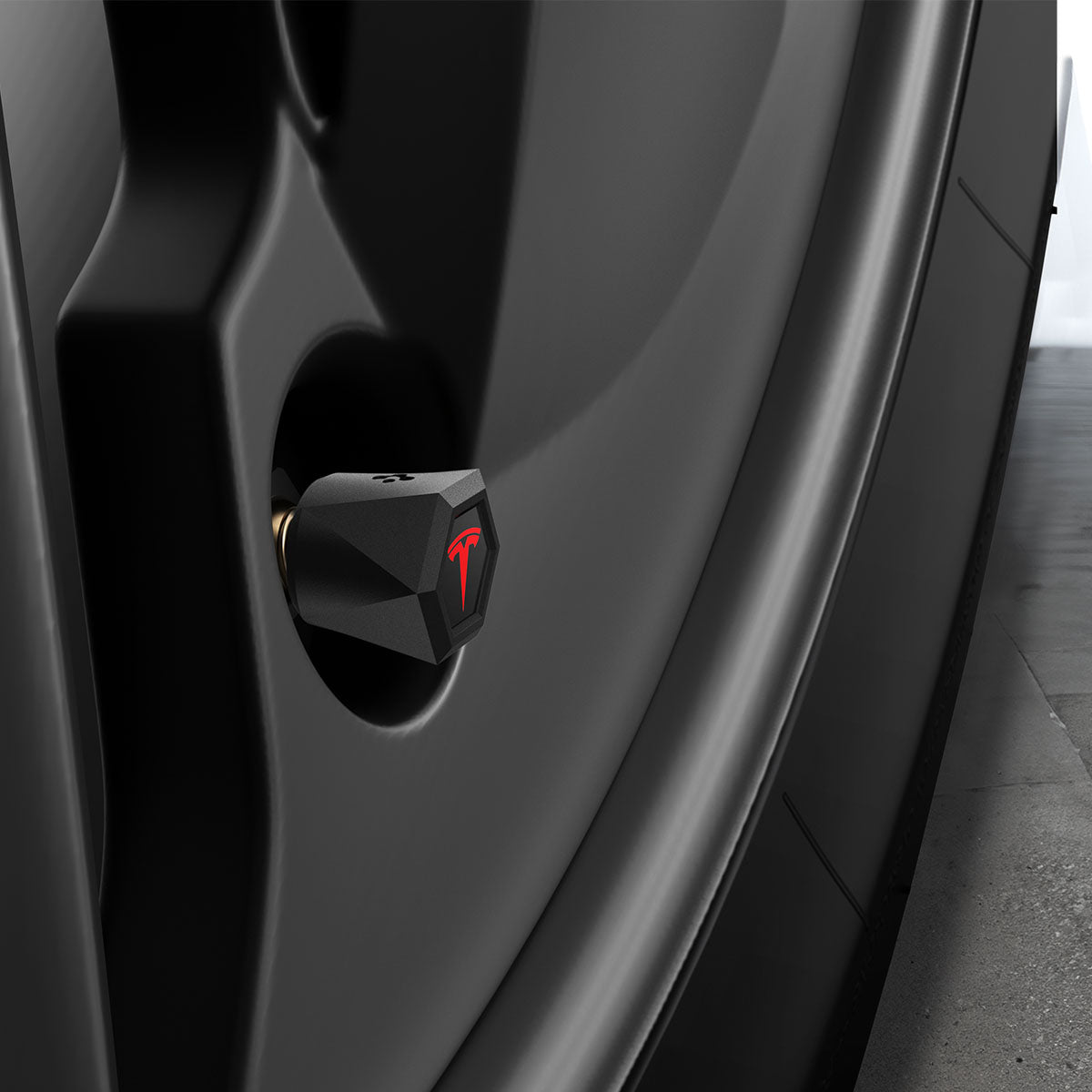 ACP11371 - Universal Tire Valve Stem Cap | VS100TS/R in Red showing a side view of the matte black hexagonal cap with red Tesla logo installed on a vehicle wheel valve stem.