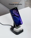 ACS11144 - AirPods Pro 3 Classic Fit case charging wirelessly on a desk with a smartphone on a charging stand, showing LED indicator and textured fabric finish