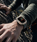 ACS11889 - Apple Watch Series 12 (46mm) Case Rugged Armor in Dune Beige showing the rugged protective case worn during an outdoor climbing activity