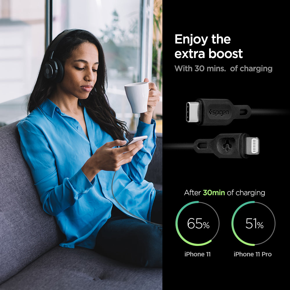 000CA27022 - DuraSync™ USB-C to Lightning Cable C10CL in Black showing the Enjoy the extra boost. With 30 mins. of charging. After 30 mins of charging, iPhone 11 (65%) and iPhone 11 Pro (51%). also showing 2 cable heads and a woman sitting holding a mug and a device in another hand