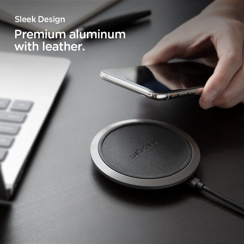 000CH23122 - Essential® Leather Designed 10W Wireless Charger F308W in Black showing the Sleek Design, Premium aluminum with leather. A hand holding a device facing it in front of a wireless charger pad