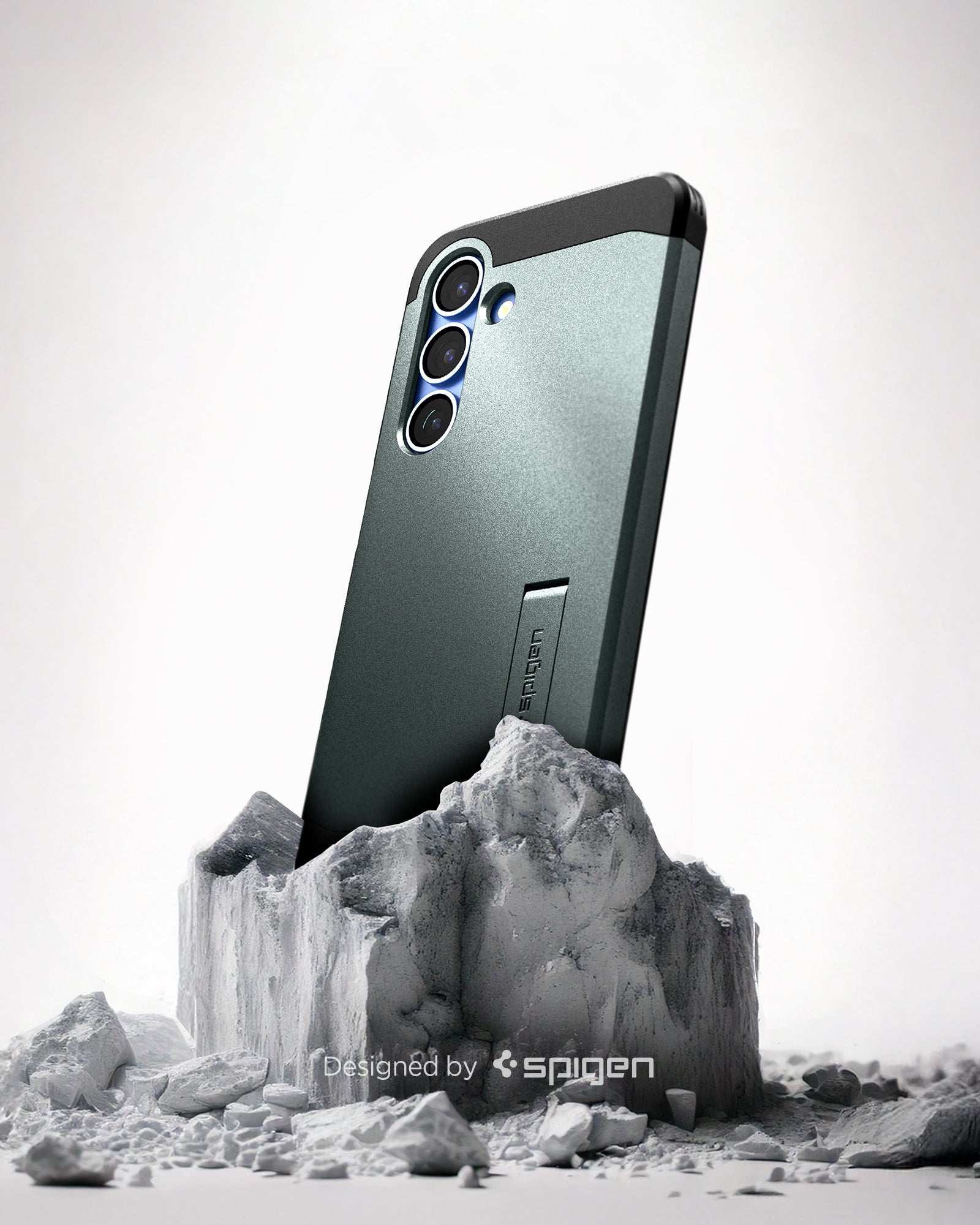 ACS08989 - Galaxy S25 Plus Case Tough Armor AI (MagFit) in Abyss Green showing the back, partial side device sitting on the top of a rock