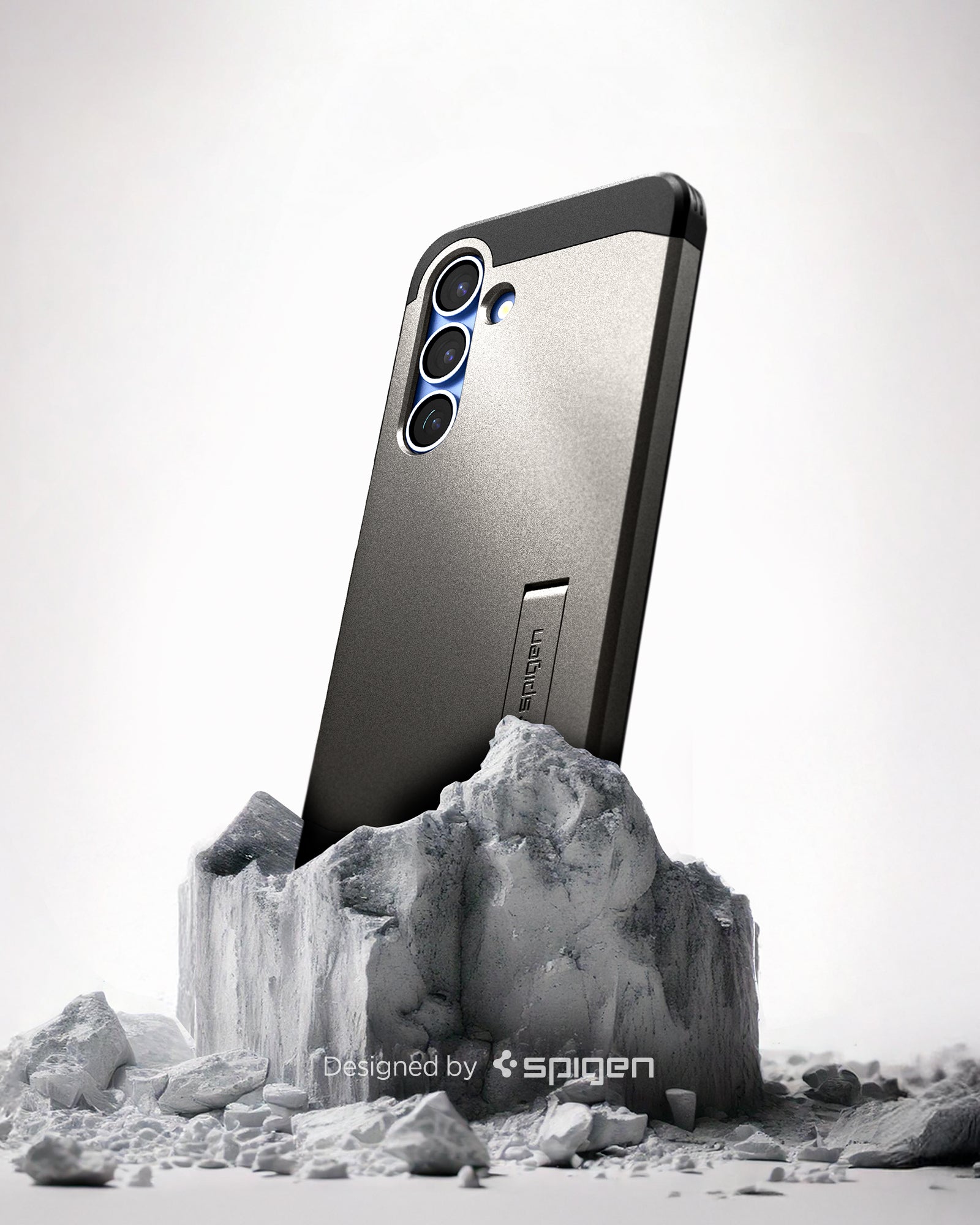 ACS08988 - Galaxy S25 Plus Case Tough Armor AI (MagFit) in Gunmetal showing the back, partial side device sitting on top of the rock