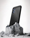 ACS09008 - Galaxy S25 Case Tough Armor AI (MagFit) in Black showing the back, partial side device sitting on the top of a rock
