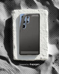 ACS08952 - Galaxy S25 Ultra Case Rugged Armor (MagFit) in Marble Gray designed by spigen. Showing the phone with the pattern on the sand. 