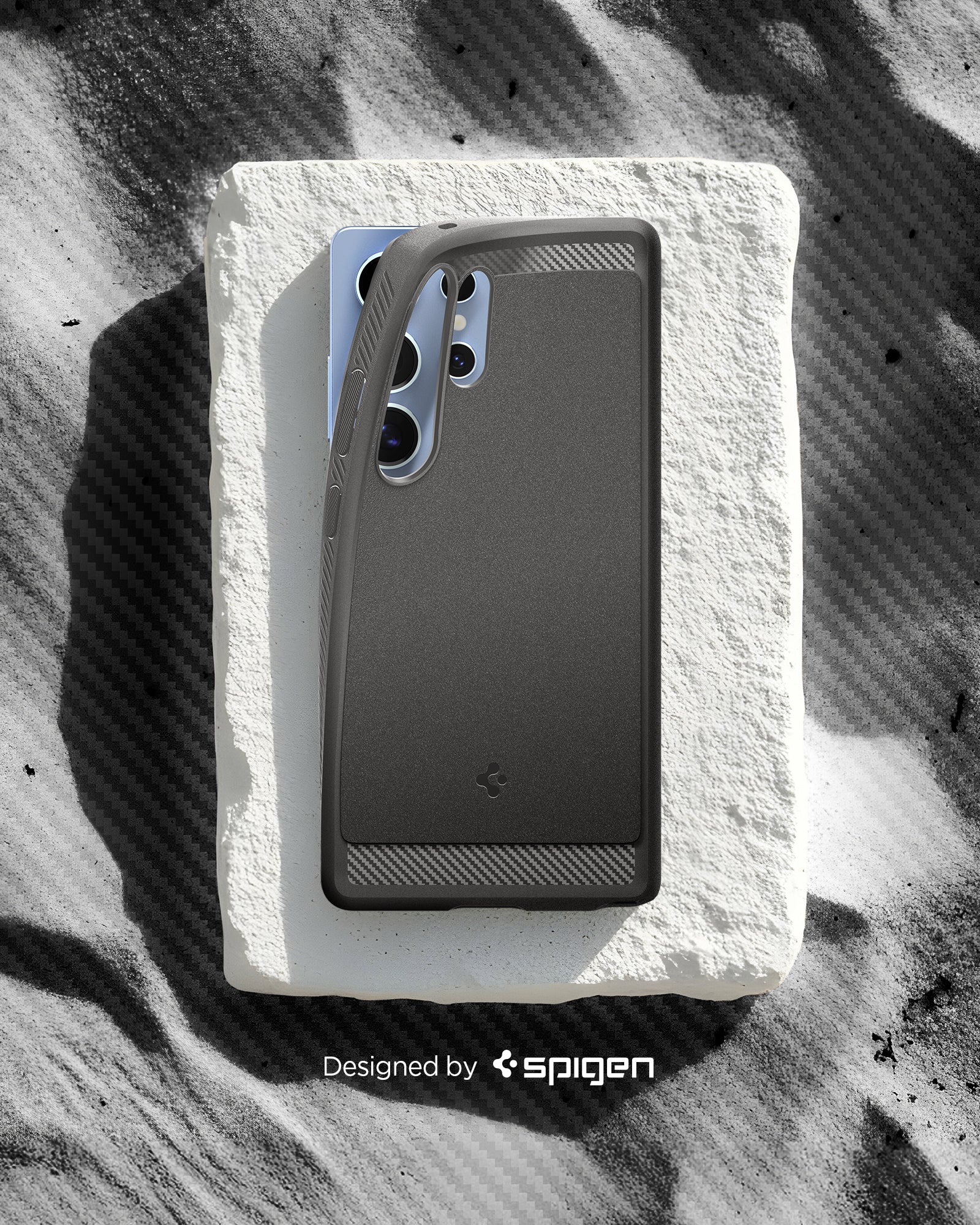 ACS08952 - Galaxy S25 Ultra Case Rugged Armor (MagFit) in Marble Gray designed by spigen. Showing the phone with the pattern on the sand. 