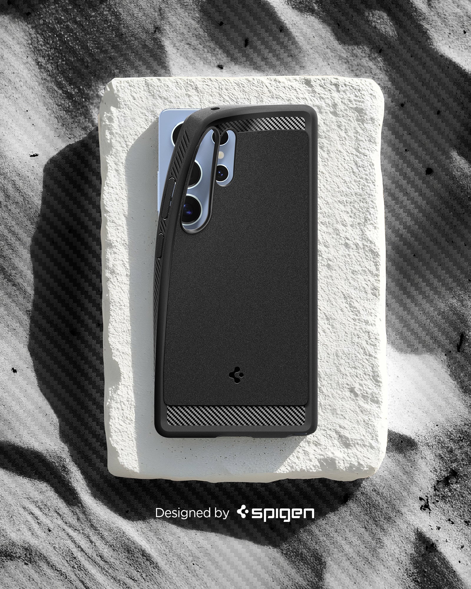 ACS08951 - Galaxy S25 Ultra Case Rugged Armor (MagFit) in Matte Black designed by spigen. Showing the phone with the pattern on the sand.