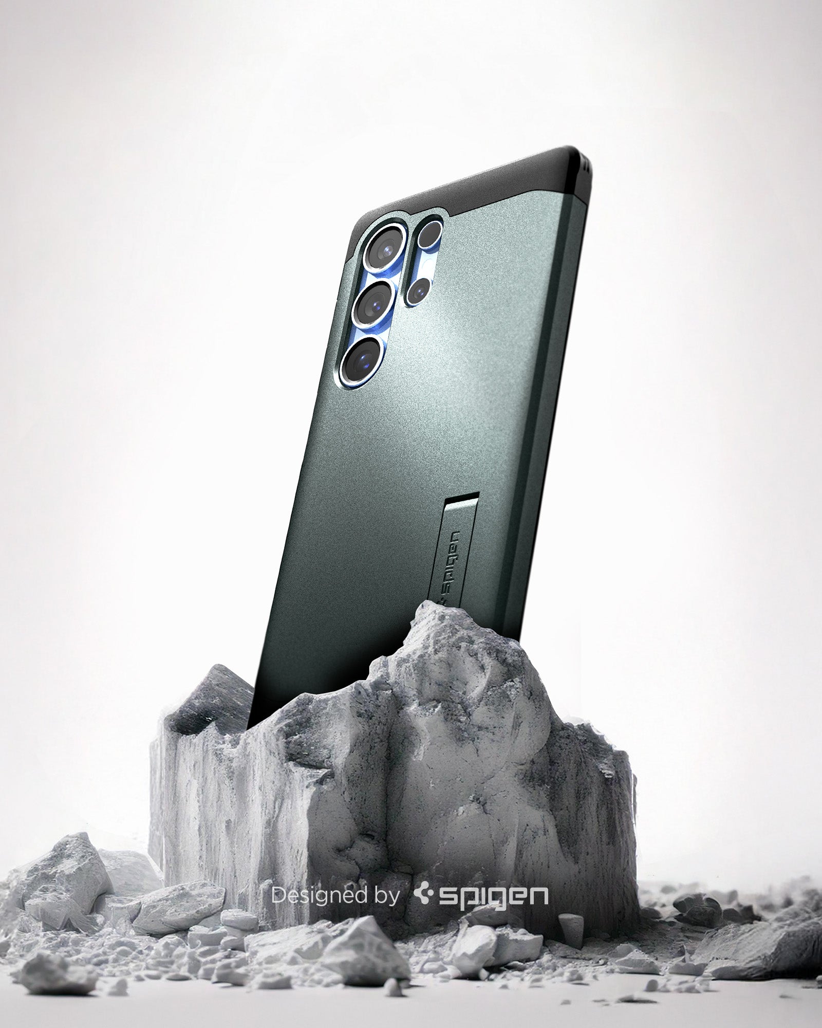 ACS08966 - Galaxy S25 Ultra Case Tough Armor AI (MagFit) in Abyss Green showing the back, partial side device sitting on the top of a rock
