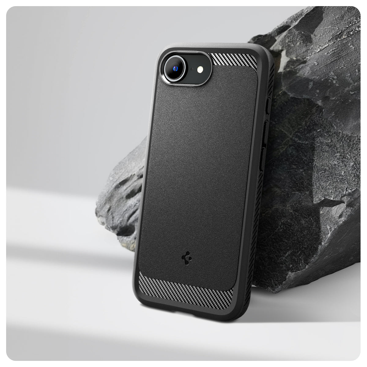 ACS09152 - iPhone 16e Case Rugged Armor (MagFit) in Matte Black showing the back and partial side device leaning on a rock