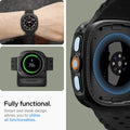 ACS11610 - Watch Ultra (47mm) Liquid Air in Matte Black showing a smartwatch worn on a wrist, placed on a charging dock, and viewed from the back with exposed sensors.