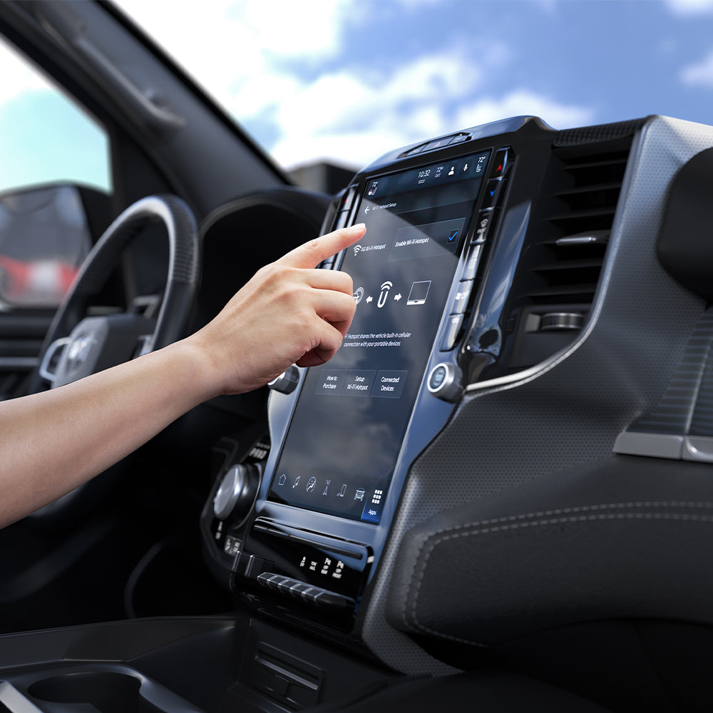 AGL04047 - Dodge Ram Screen Protector GLAS.tR SLIM Anti-Glare showing hand tapping Ram infotainment touchscreen with screen protector applied inside truck cabin