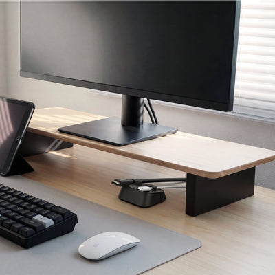 APP11145 - Magnetic Cable Holder | LD103 showing the magnetic cable holder placed under a monitor stand organizing charging cables on a desk